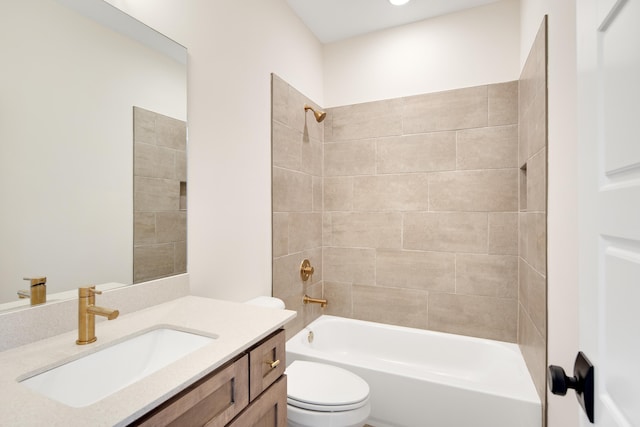 full bathroom with vanity, tiled shower / bath combo, and toilet