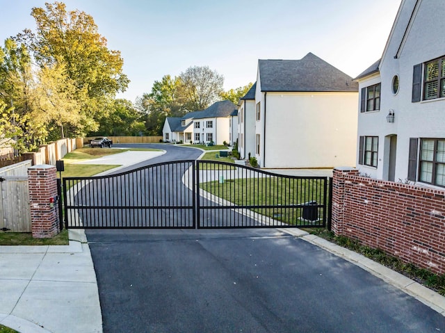 view of gate with a yard