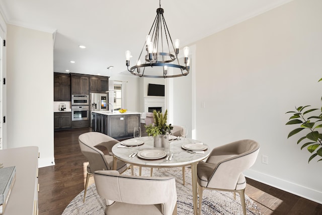 dining room featuring crown molding, dark hardwood / wood-style floors, and a notable chandelier