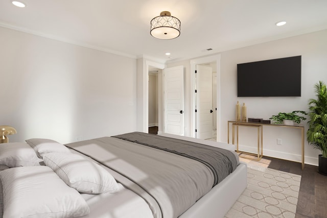 bedroom featuring hardwood / wood-style floors and crown molding