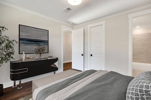 bedroom with ensuite bath, dark wood-type flooring, and ornamental molding