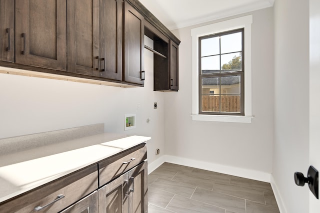 clothes washing area featuring cabinets, hookup for an electric dryer, crown molding, hookup for a washing machine, and gas dryer hookup