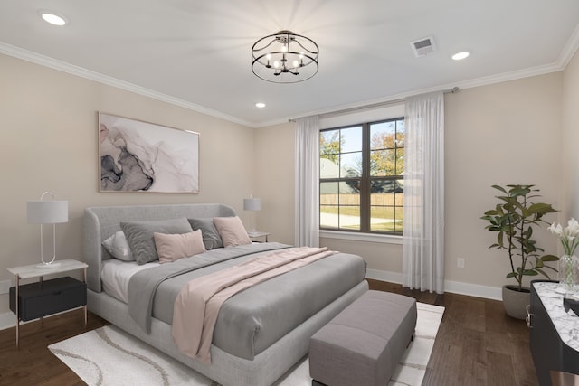 bedroom featuring dark hardwood / wood-style flooring, an inviting chandelier, and crown molding