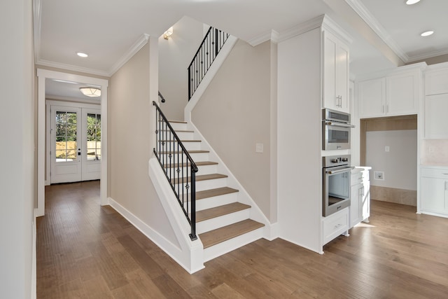 stairs featuring wood-type flooring, french doors, and crown molding