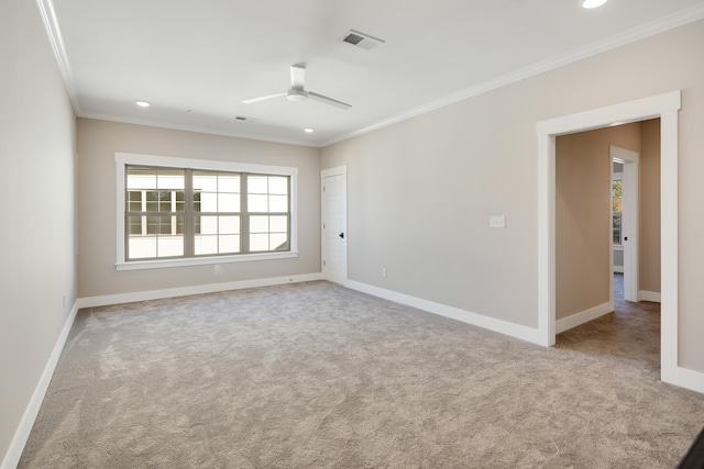 carpeted empty room featuring ceiling fan and ornamental molding