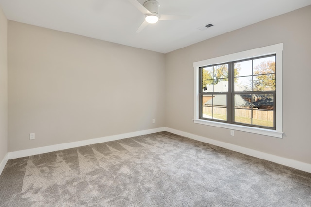 carpeted spare room with ceiling fan