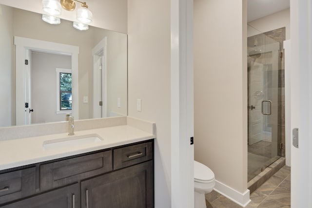 bathroom with tile patterned floors, vanity, toilet, and a shower with door