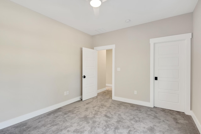 unfurnished bedroom featuring light carpet and ceiling fan