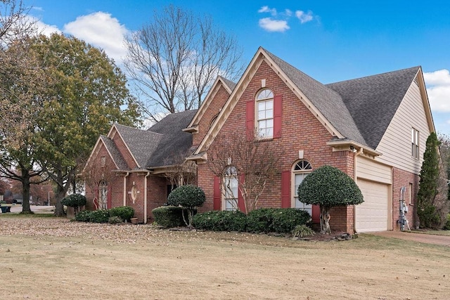 front facade featuring a garage and a front yard