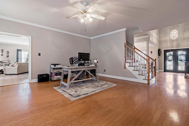 office area with crown molding, ceiling fan, decorative columns, wood-type flooring, and french doors