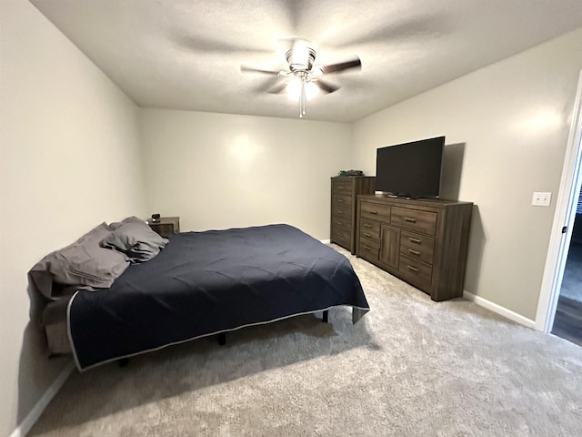 bedroom featuring ceiling fan and light carpet