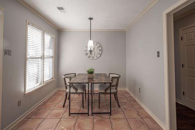 tiled dining room featuring crown molding and a textured ceiling