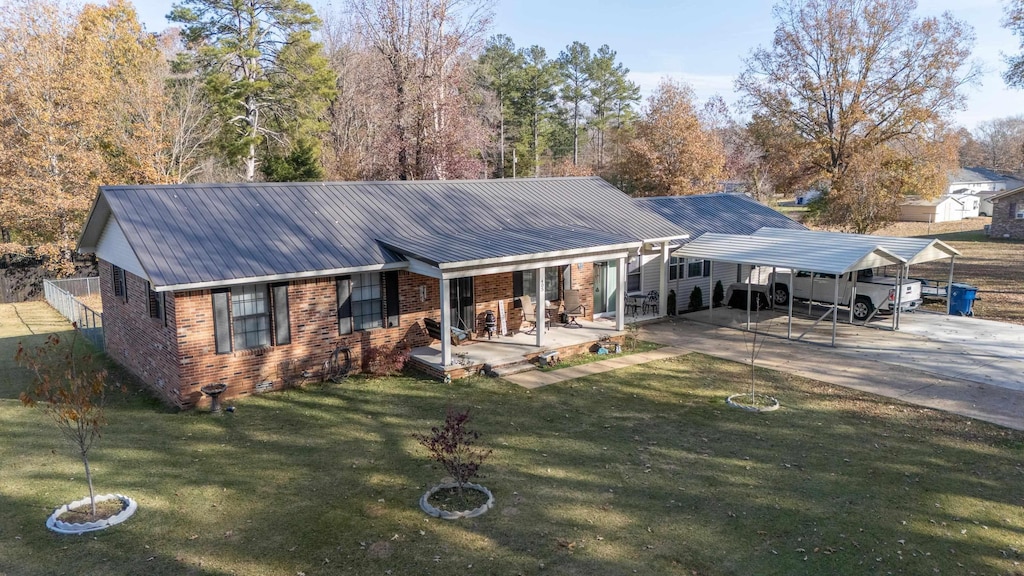 ranch-style house featuring a front yard and a carport