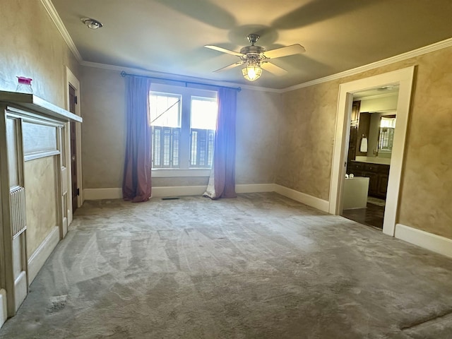 carpeted spare room featuring ceiling fan and ornamental molding