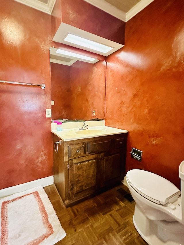 bathroom featuring vanity, toilet, parquet floors, and ornamental molding