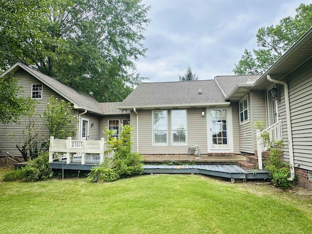 back of house with a lawn and a deck