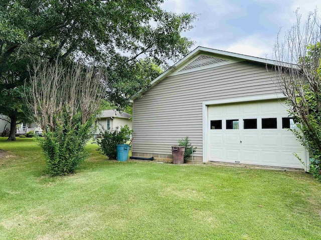 view of home's exterior featuring a garage and a yard