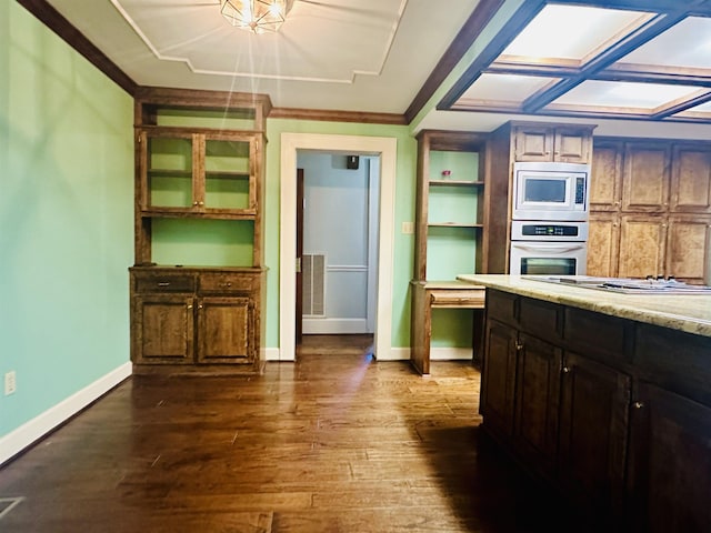 kitchen featuring dark hardwood / wood-style flooring, stainless steel appliances, and ornamental molding