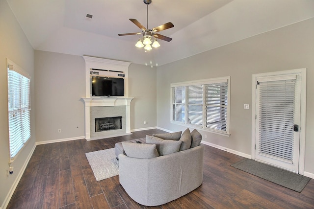 living room with dark hardwood / wood-style floors, a healthy amount of sunlight, and ceiling fan