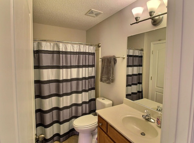 bathroom with vanity, a textured ceiling, toilet, and curtained shower