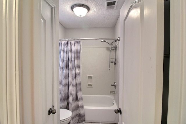 bathroom with shower / bath combination with curtain, a textured ceiling, and toilet