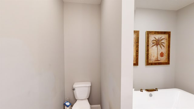 bathroom featuring a tub and toilet