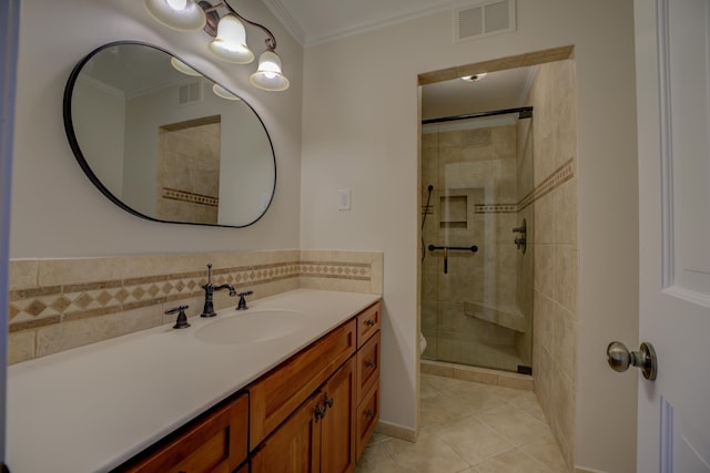 bathroom featuring tile patterned floors, vanity, a shower with door, crown molding, and toilet