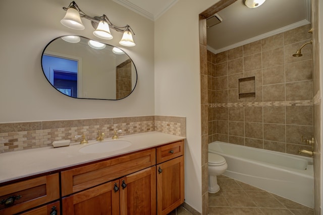 full bathroom with tiled shower / bath combo, tile patterned floors, crown molding, toilet, and vanity