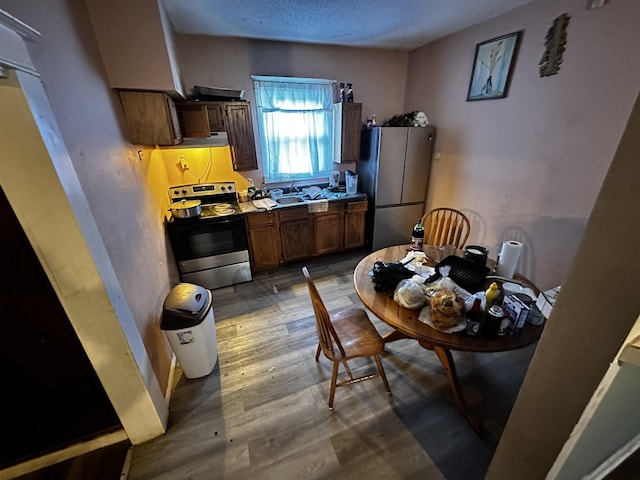 kitchen featuring hardwood / wood-style floors, stainless steel appliances, and sink