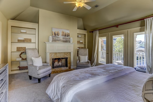 carpeted bedroom with access to outside, ceiling fan, a fireplace, and lofted ceiling