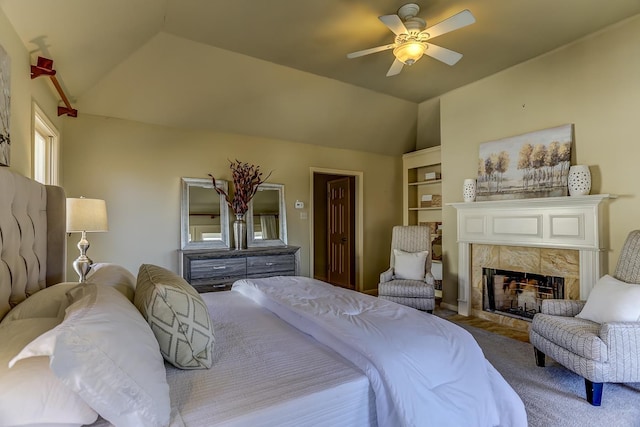 bedroom with a fireplace, carpet, vaulted ceiling, and ceiling fan