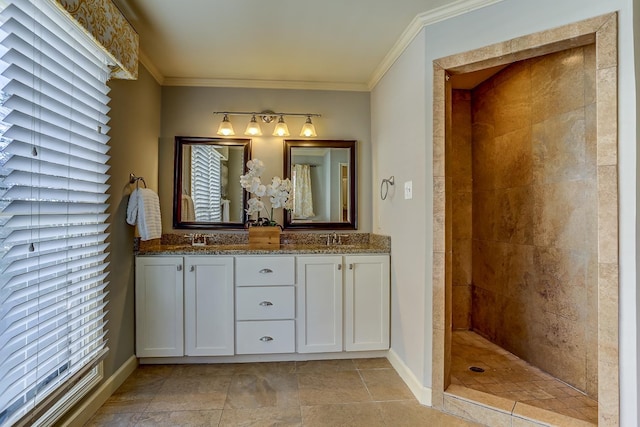 bathroom with tiled shower, vanity, and ornamental molding