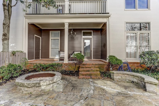 entrance to property featuring a balcony and a patio area