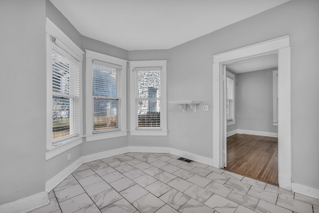 spare room with plenty of natural light and light wood-type flooring