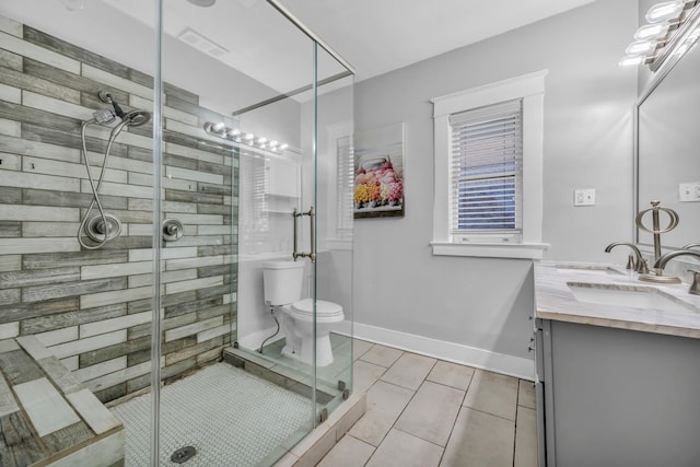 bathroom with toilet, vanity, tile patterned floors, and walk in shower