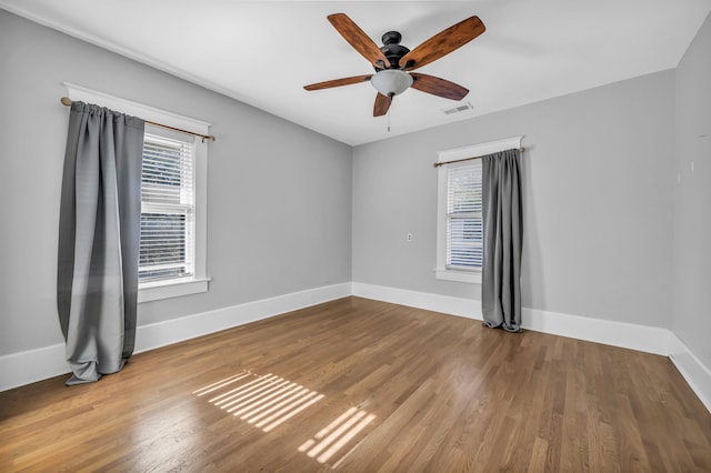 unfurnished room with hardwood / wood-style floors and ceiling fan