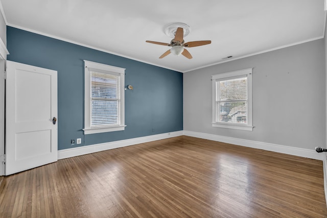 empty room with hardwood / wood-style flooring, ceiling fan, and crown molding