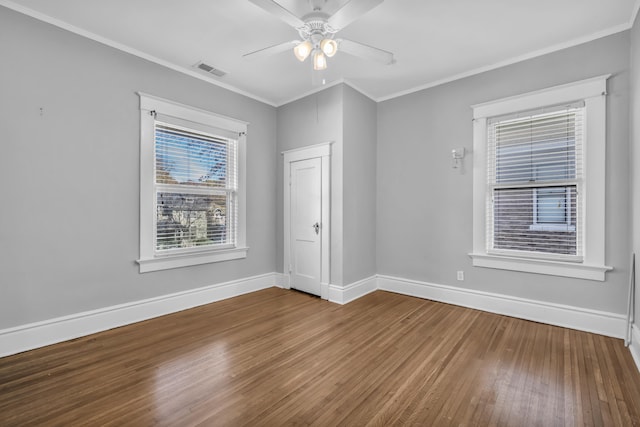 unfurnished room featuring ceiling fan, wood-type flooring, and crown molding