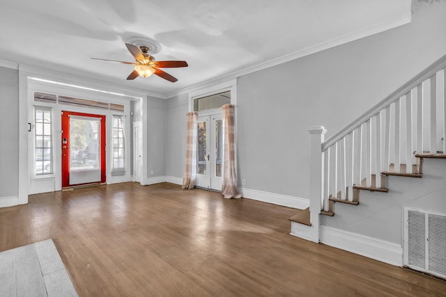 foyer entrance with ornamental molding, ceiling fan, and dark wood-type flooring