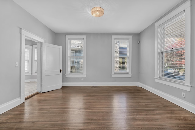 unfurnished room featuring dark hardwood / wood-style floors