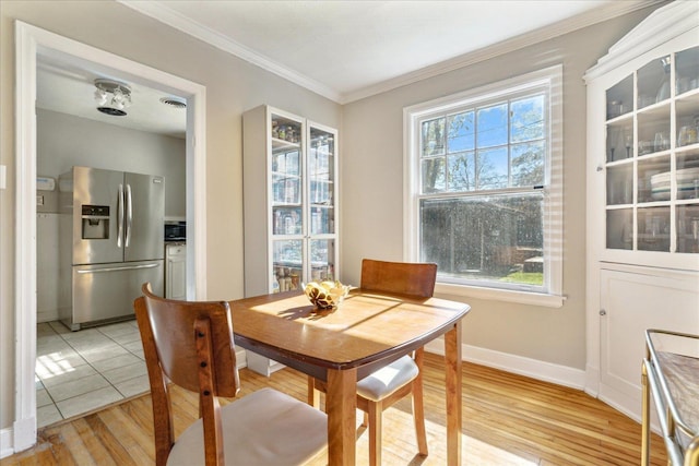 dining room featuring light hardwood / wood-style floors and ornamental molding