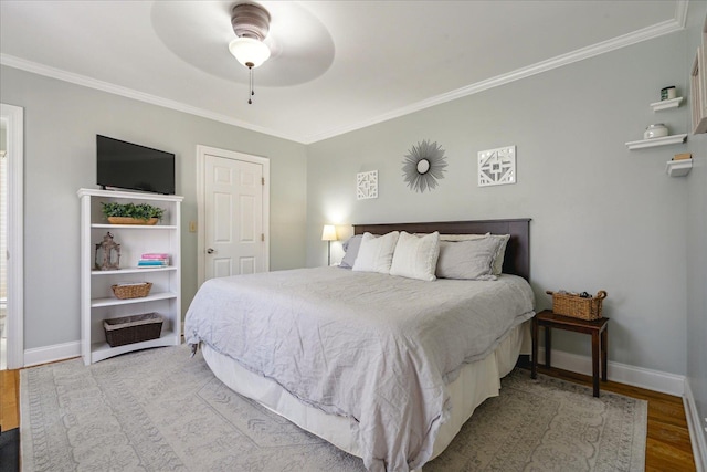 bedroom with light hardwood / wood-style floors, ceiling fan, and crown molding