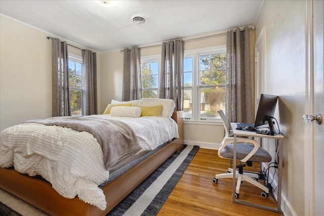 bedroom with hardwood / wood-style flooring