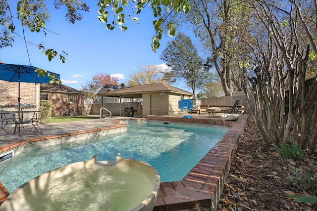 view of pool with a patio area and an in ground hot tub