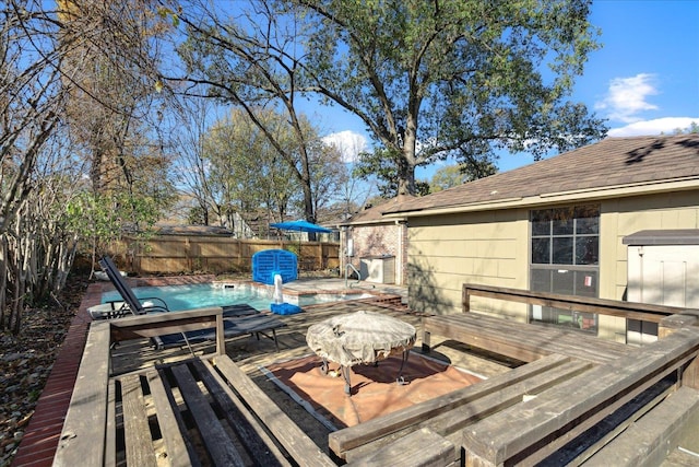 wooden deck featuring a swimming pool with hot tub