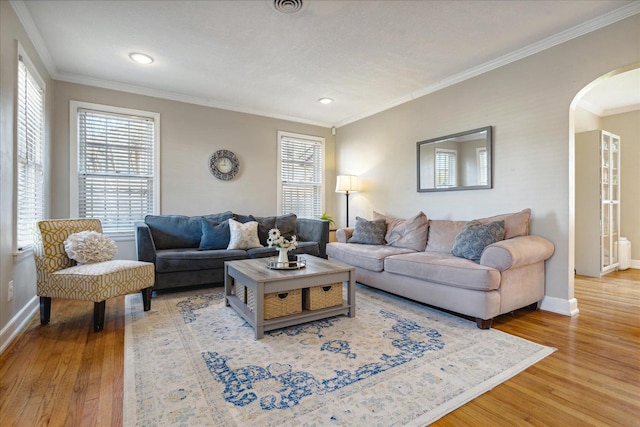 living room with wood-type flooring and ornamental molding