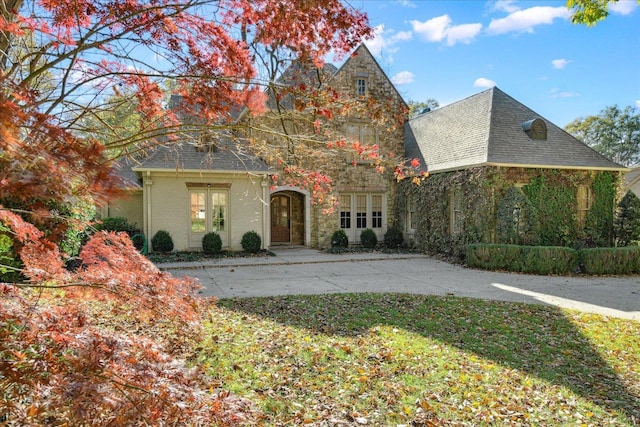 view of front facade featuring french doors and a front lawn