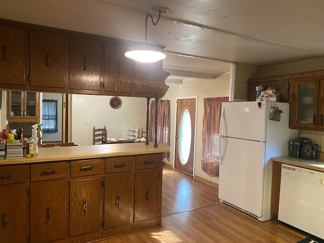 kitchen with white appliances and light hardwood / wood-style flooring