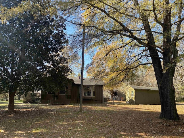 view of front of house with a storage shed