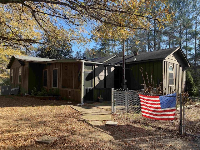 view of home's exterior with a sunroom